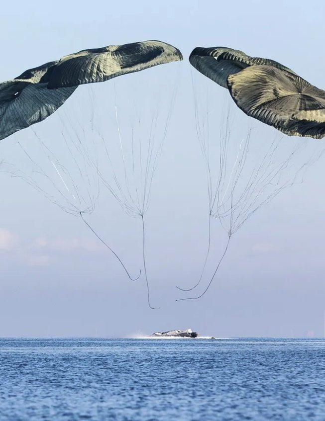 Twin cargo canopies releasing a boat onto the water