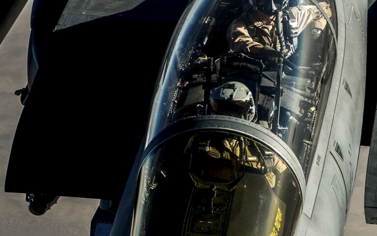 Fast-jet cockpit and forward airframe viewed from a tanker during aerial refuelling